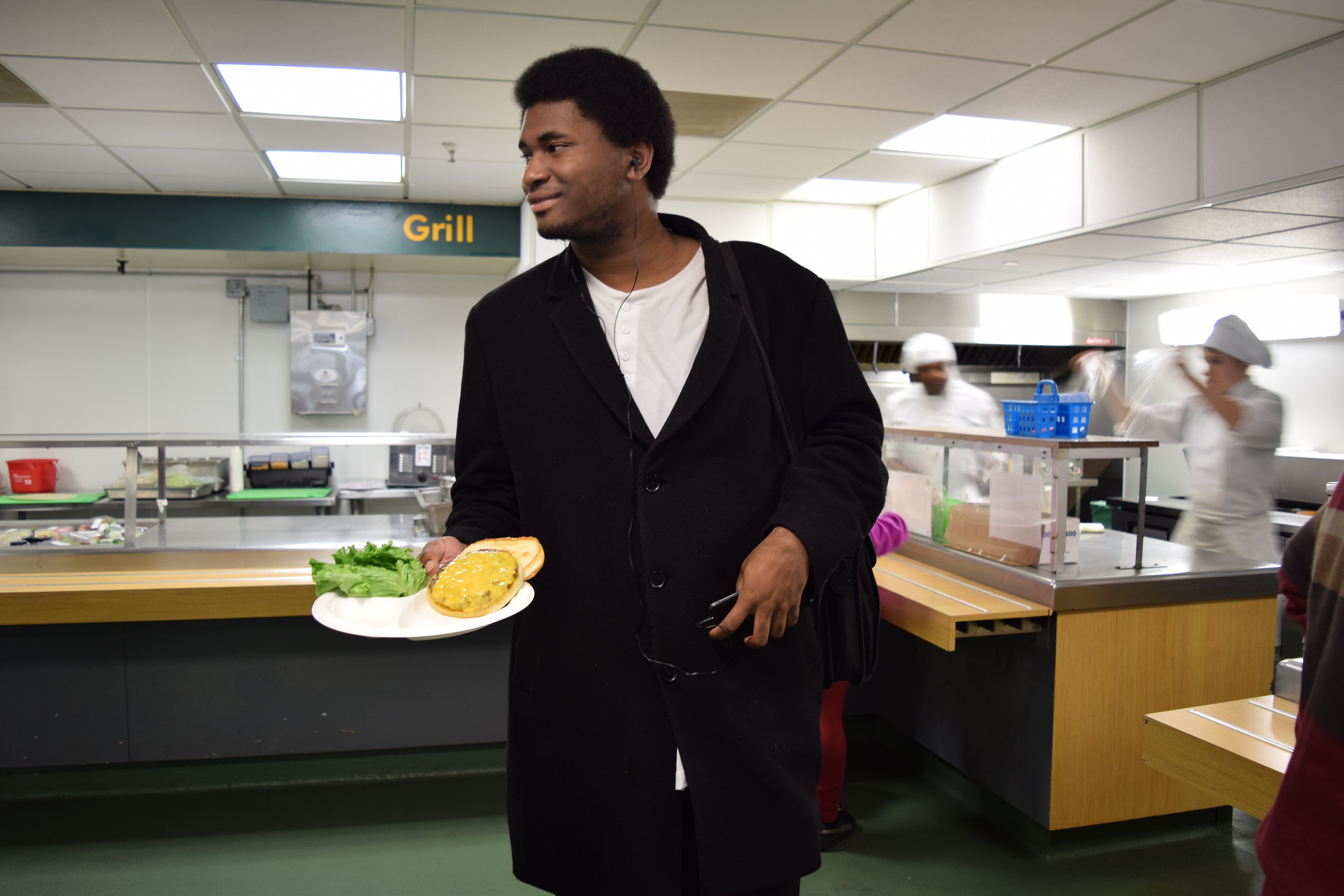 Student Darren Owen, a computer science major, seems ready to enjoy his Laney College main cafeteria grilled burger on Nov 29, 2017. (Photo by Barbara Muniz)