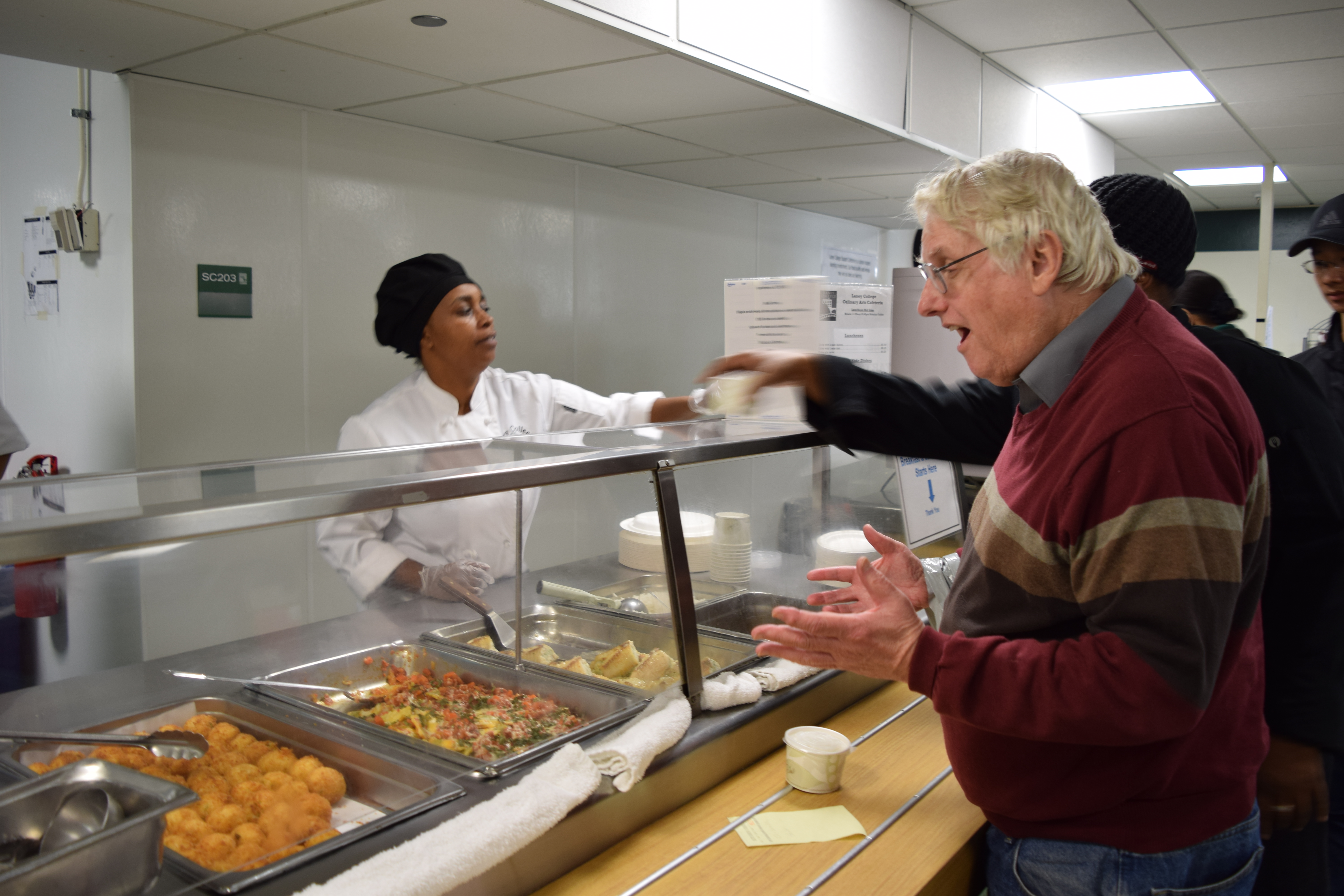 Laney college journalism instructor Scott Strains seems happy to see potato croquette as part of the manu that Laney College main cafeteria serves on Nov. 29, 2017. (Photo by Barbara Muniz) 