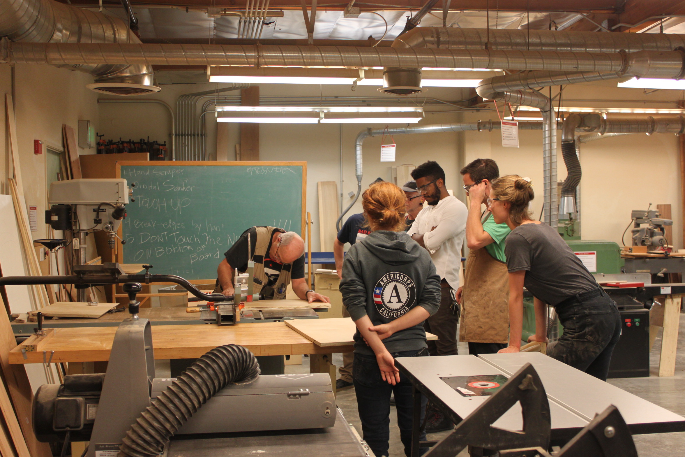 Raymond Cash leads the class in instruction before students disburse throughout the woodshop to work on their individual projects. Photo taken by Bethaney Lee on Nov. 6, 2017. 
