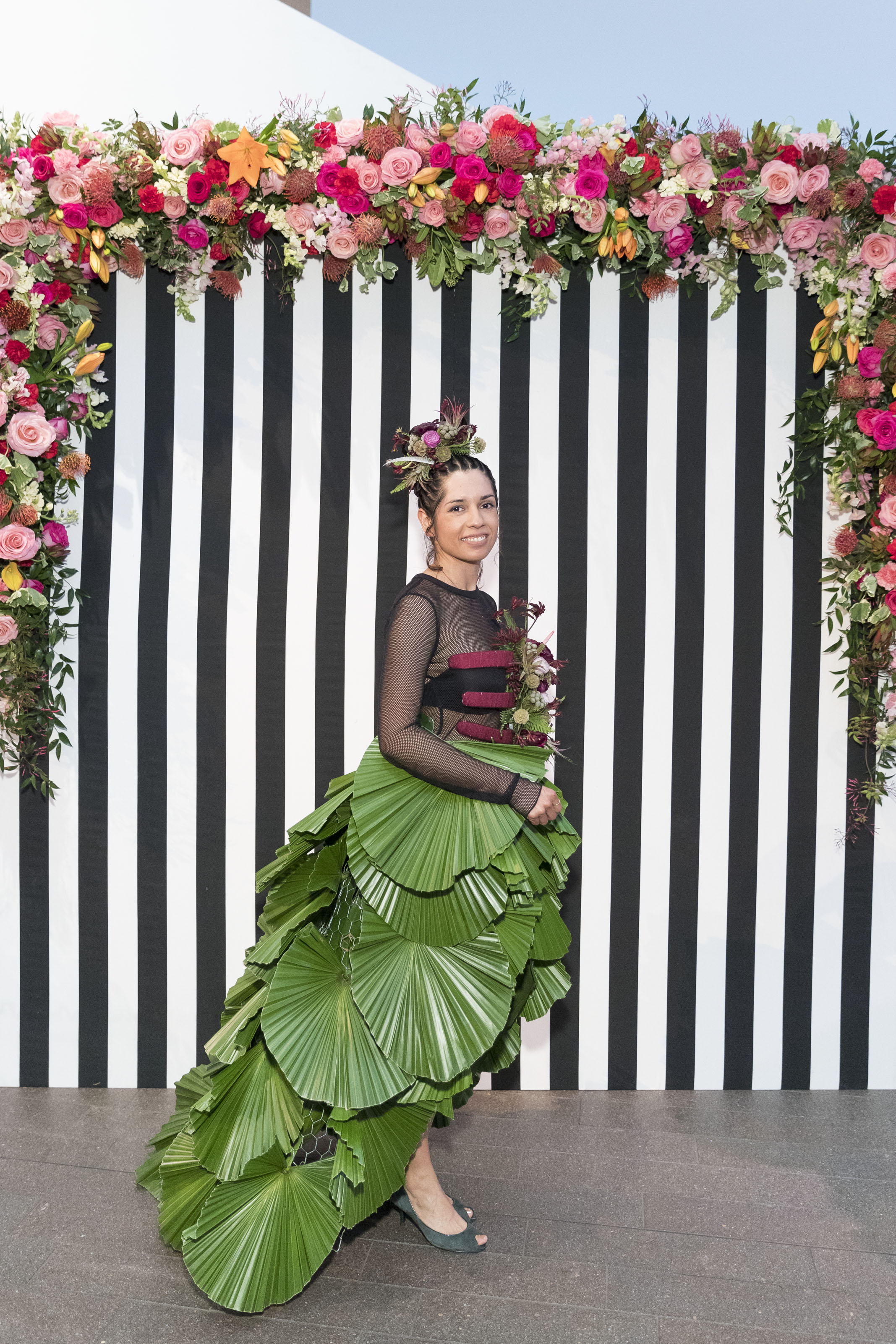 Liberty Velez models Rosa Mendoza's dress with a long train of pal leaves on March 12, 2018. Photo by Drew Altizer/Courtesy of the Fine Arts Museums of San Francisco.