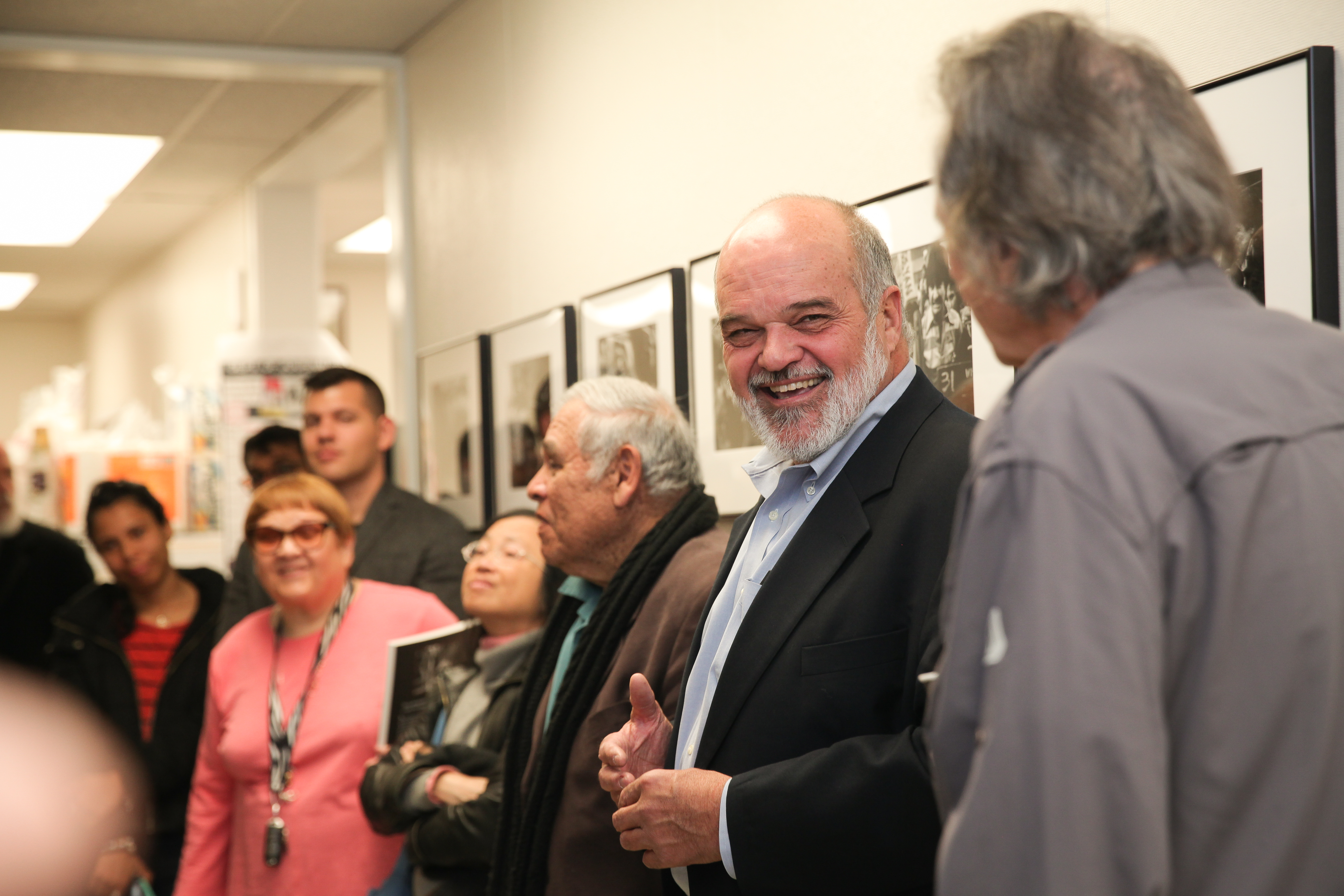 (L-R) Department Chair of Journalism department Juan Gonzales, and two featured artists; Pulitzer Prize-winning photojournalist Kim Komenich and former Reuters Photo Bureau Chief Lou Dematteis give a speech during the opening reception of “In the Line of Fire” a photo exhibition featuring rare war zone photographs at Front Page Gallery in City College of San Francisco Department of Journalism on Friday, April 13, 2018 in San Francisco, Calif. (Photo by Ekevara Kitpowsong)