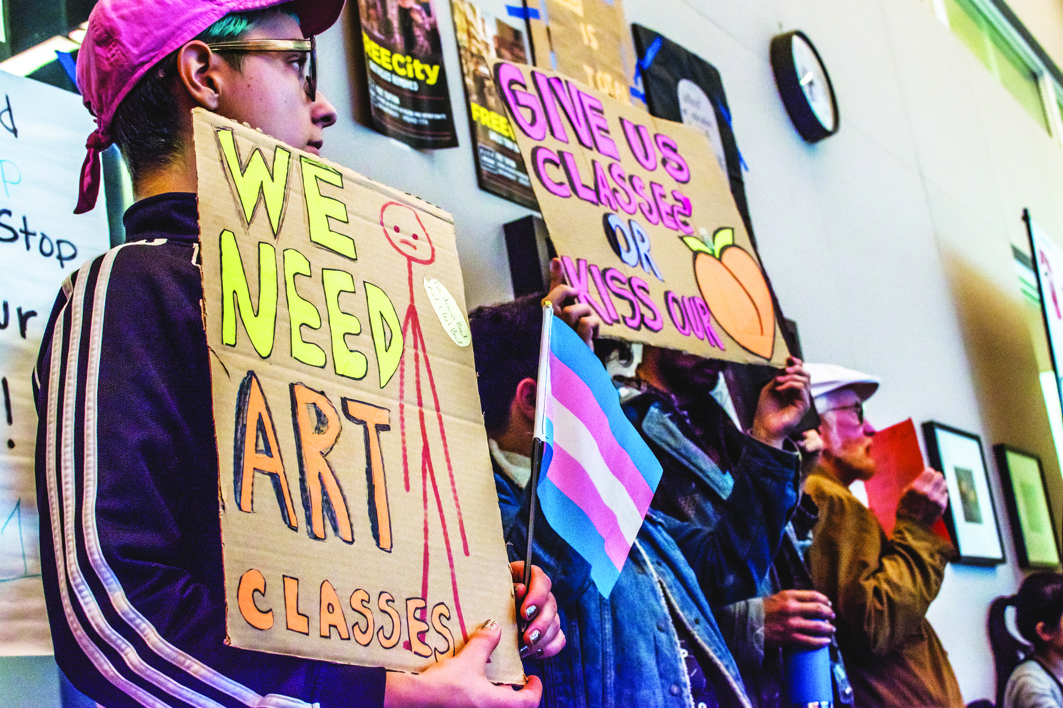 Hold Sall Vesselényi, left, protests with other students representing City College's Queer Resource Center during public comment.