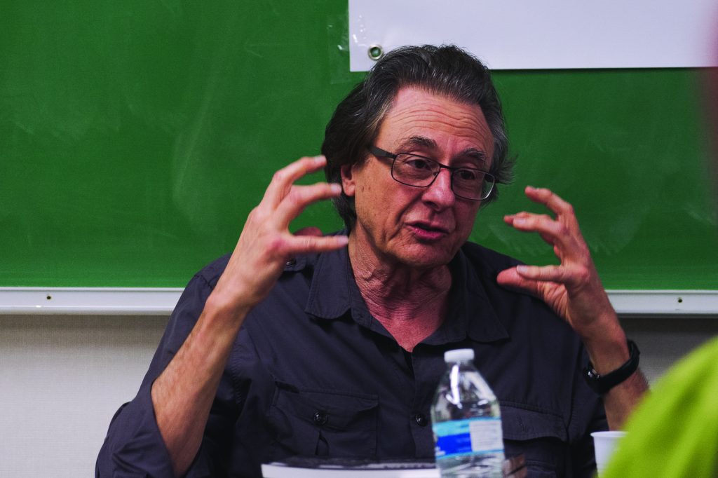 Lou Dematteis, a San Francisco based photojournalist and filmmaker, speaks about reporting and photographing in Nicaragua during the 1985-1990 U.S.backed Contra War during City College's Journalism Matters month on October 19, 2018. The stack of books in front of him are titled"Nicaragua: A decade of Revolution". Photo by Cliff Fernandes.